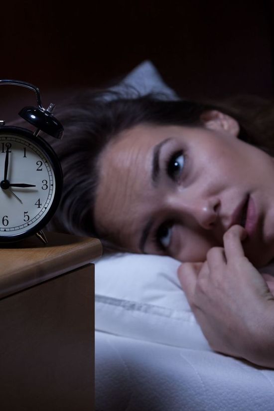 Person lying awake with insomnia at night